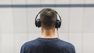 Airplane passenger using ear protection to prevent hearing damage