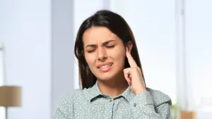 Adult experiencing ear pressure and popping