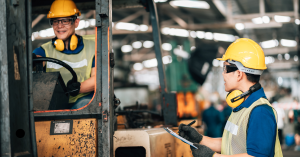 Construction worker wearing earmuffs to protect hearing from noise exposure