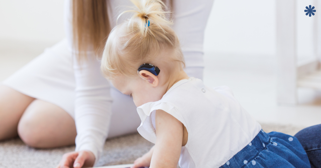 A child with hearing aids listening attentively to a parent