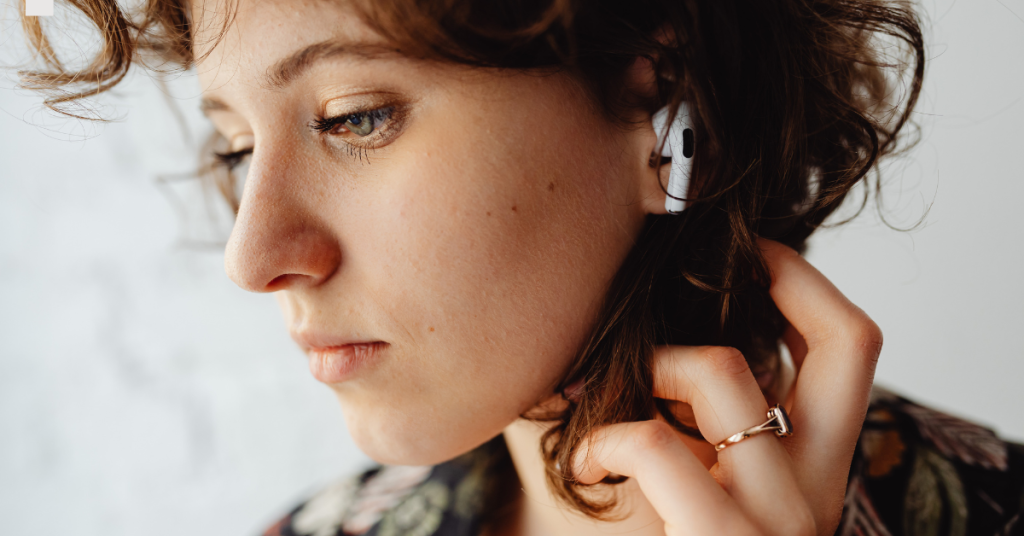 Person using earbuds with a focus on ear health
