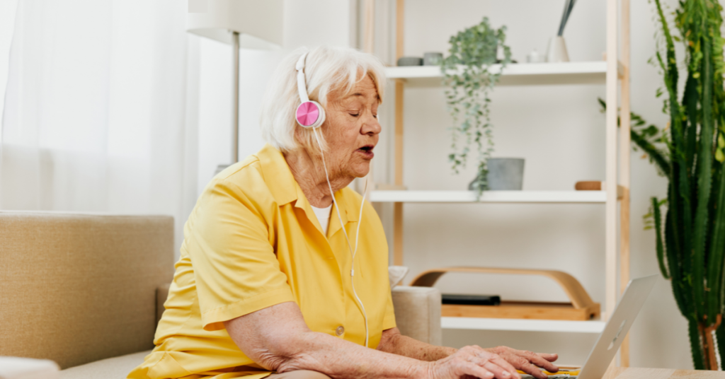 Senior taking an online hearing test using headphones