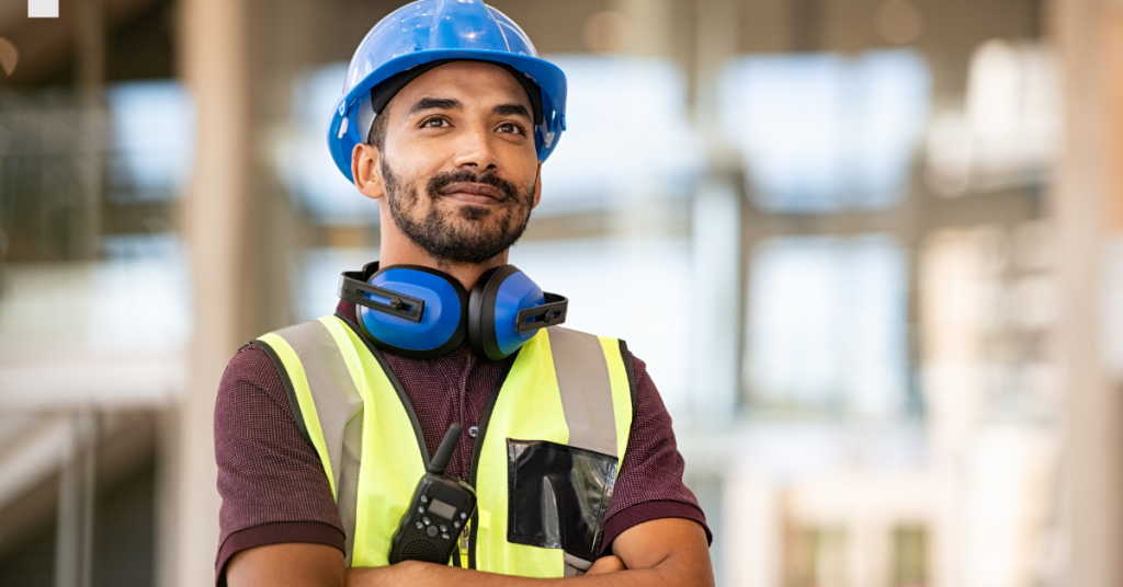 Worker wearing earmuffs for hearing protection at a noisy jobsite