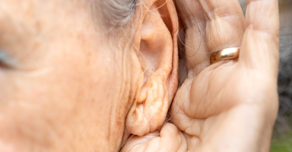 Adult experiencing muffled hearing due to congestion from a cold