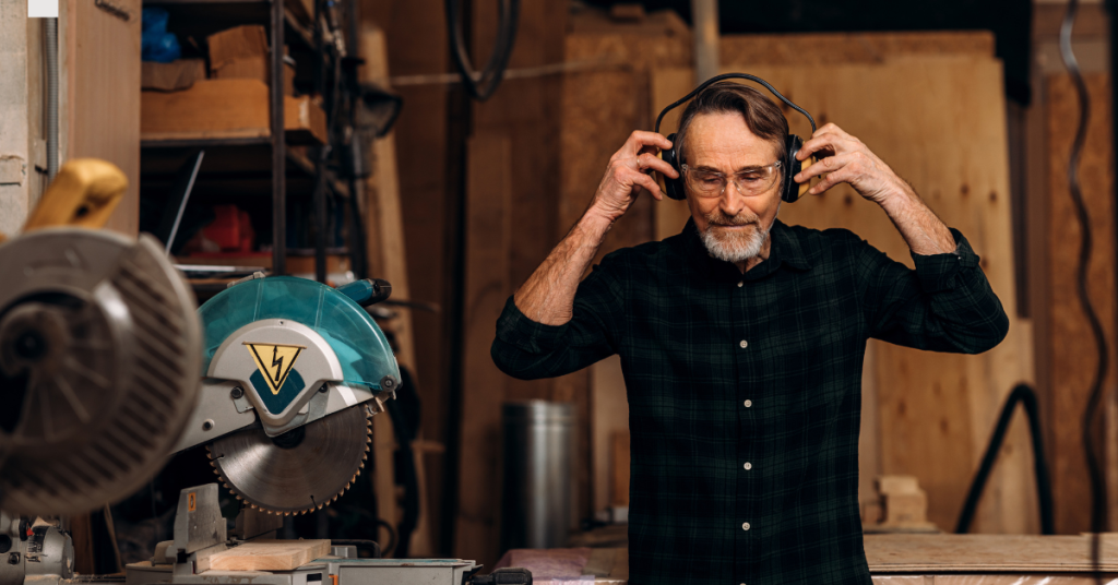Older adult using noise canceling headphones in a noisy environment