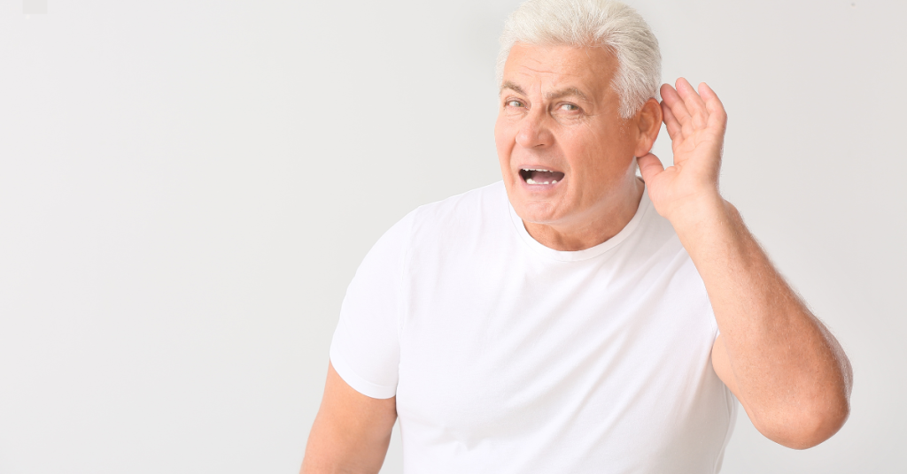 Middle-aged adult showing signs of difficulty hearing during conversation