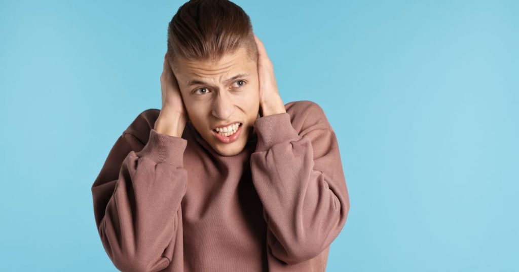 Person experiencing early signs of noise-induced hearing damage