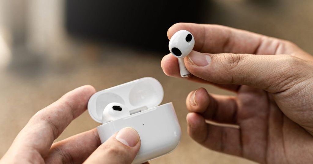 Adult using electronic earplugs for safer hearing protection