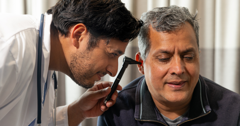 Audiologist explaining hearing test results to a patient with Auditory Neuropathy Spectrum Disorder