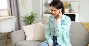 Older adult experiencing ear discomfort after a cold