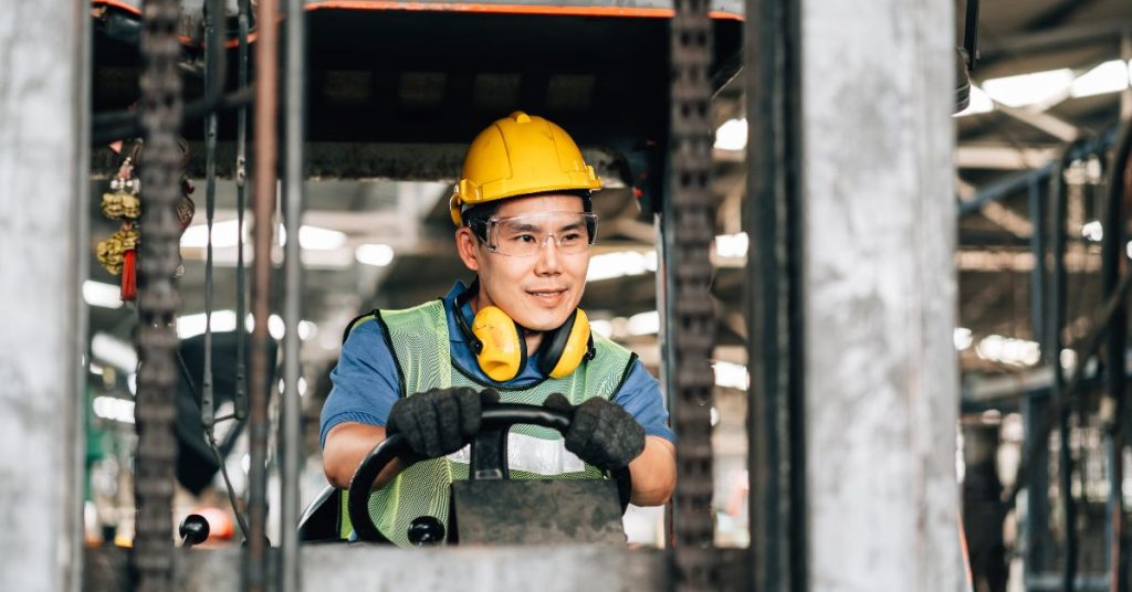 Factory workers using hearing protection to prevent hearing loss