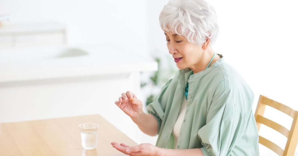 Senior reviewing medications that may affect hearing