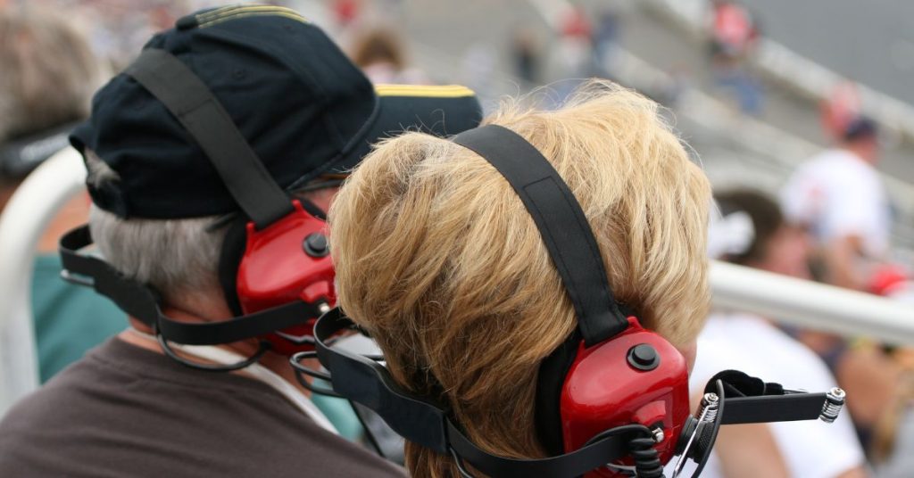 Spectator wearing hearing protection at a motor sports event