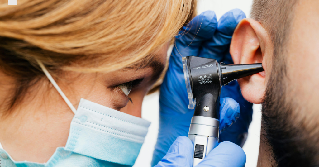 Older adult experiencing ear pain, a common symptom of ear infections