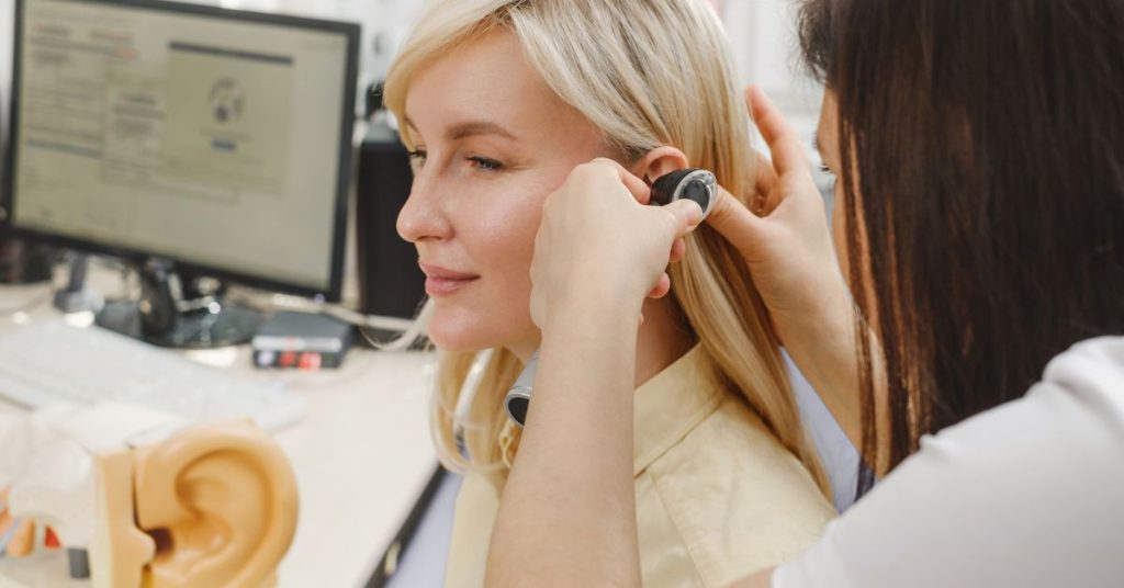 Senior adult receiving a hearing test at an audiology clinic