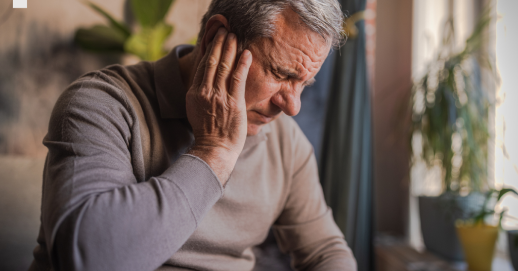 Concerned senior experiencing sudden hearing loss