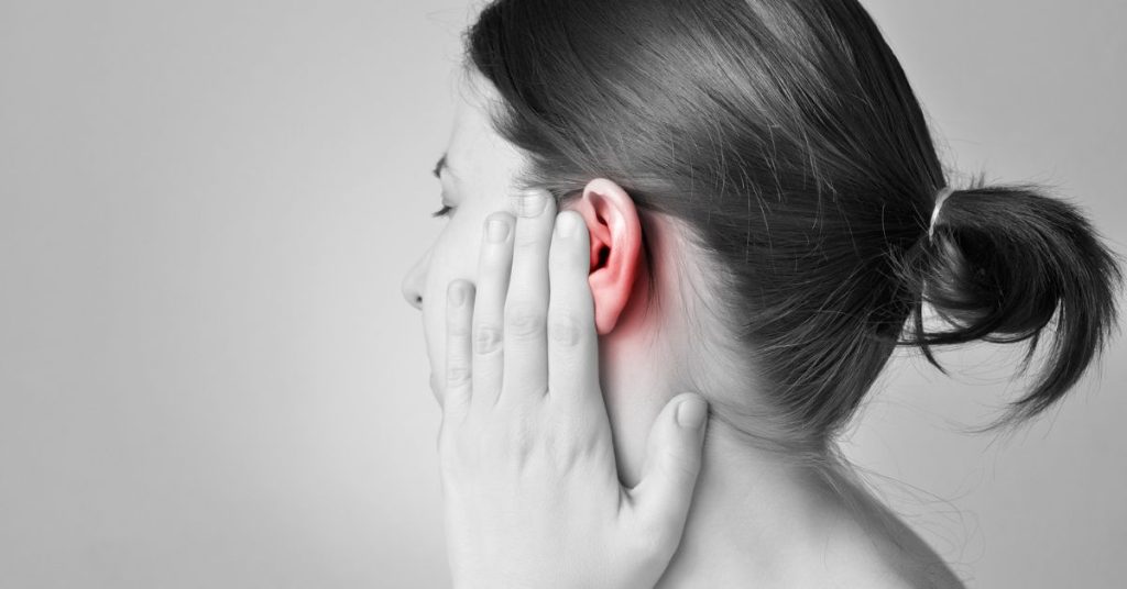 Adult experiencing a blocked ear and muffled hearing