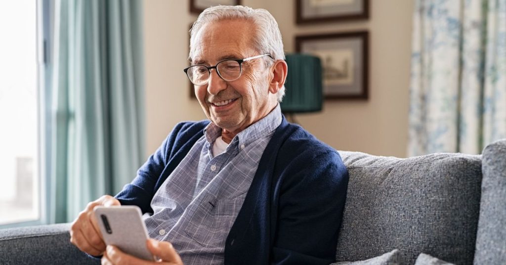 Senior adult using a hearing improvement app on a smartphone
