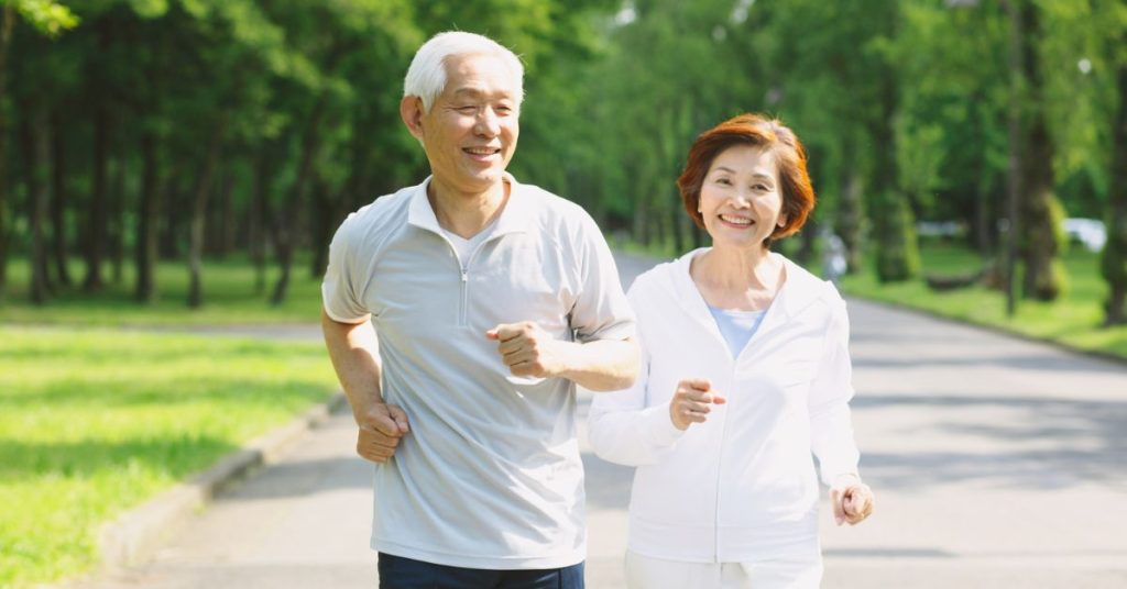 Older adult exercising outdoors to support hearing health