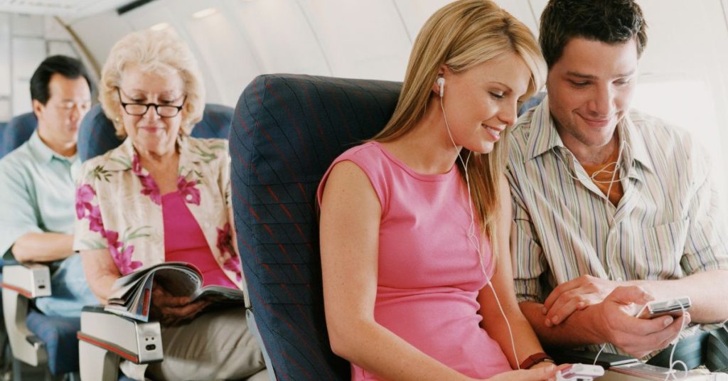 Passenger managing ear pressure while flying