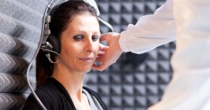 Audiologist performing a frequency-specific hearing test