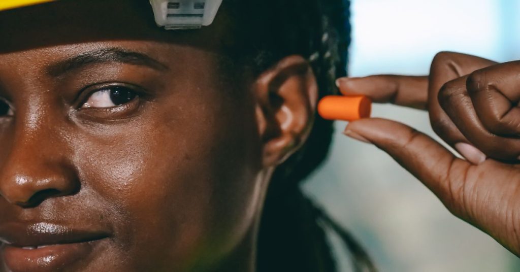 Factory workers using hearing protection equipment