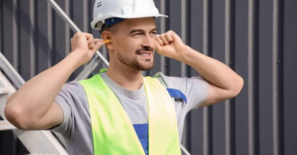 Construction worker wearing hearing protection on a noisy site
