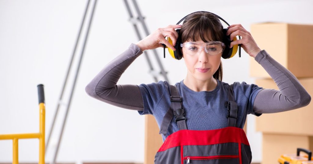 Employee using hearing protection in a noisy workplace