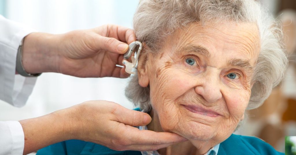 Older adult receiving a hearing aid fitting during a clinic appointment