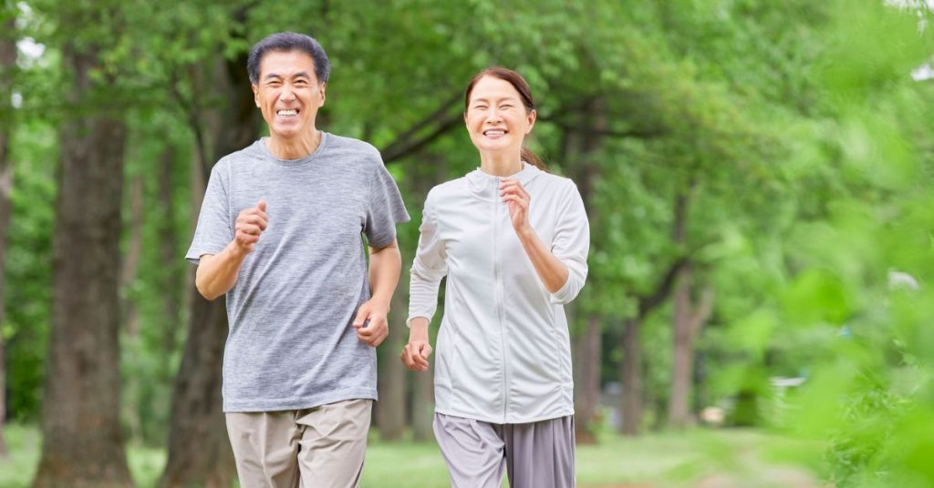 Older adult exercising outdoors to support hearing health