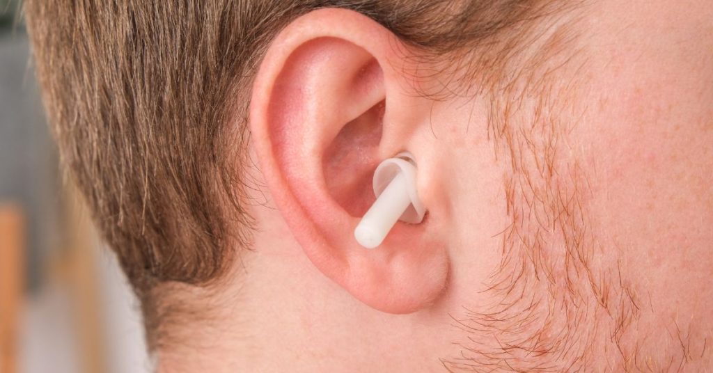 Adult practicing daily hearing protection habits