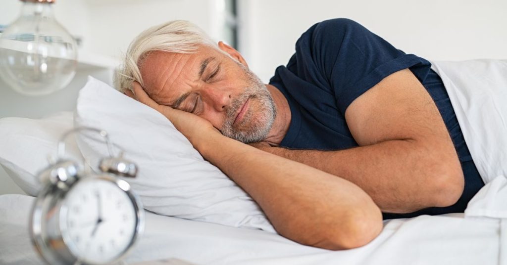 Older adult sleeping peacefully with highlighted inner ear representing hearing recovery