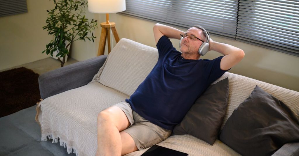 Person practicing stress relief techniques to improve tinnitus and hearing health