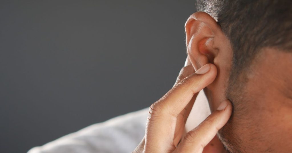 Person experiencing sudden muffled hearing