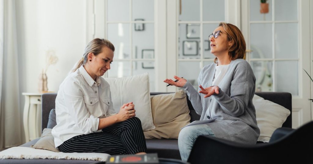 Older adult talking confidently about hearing loss with family
