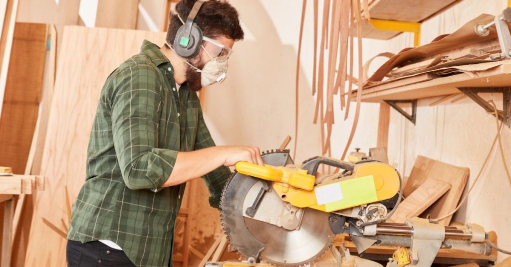 Person testing the fit of hearing protection for proper noise reduction