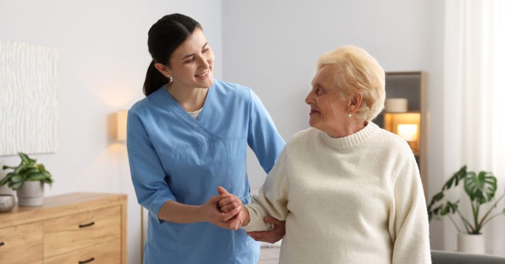 Caregiver helping older adult with hearing health resources