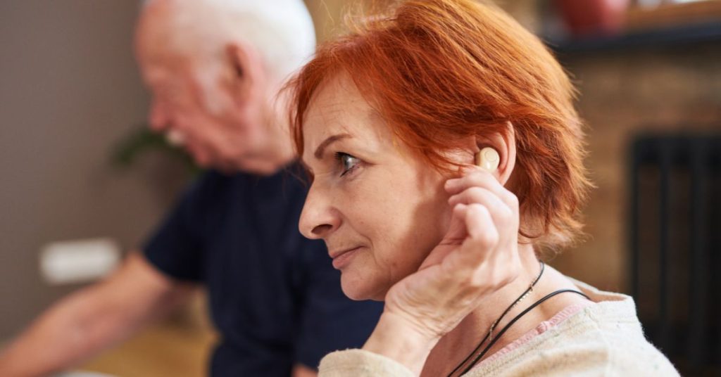 Older adult learning about hearing loss with a hearing care professional